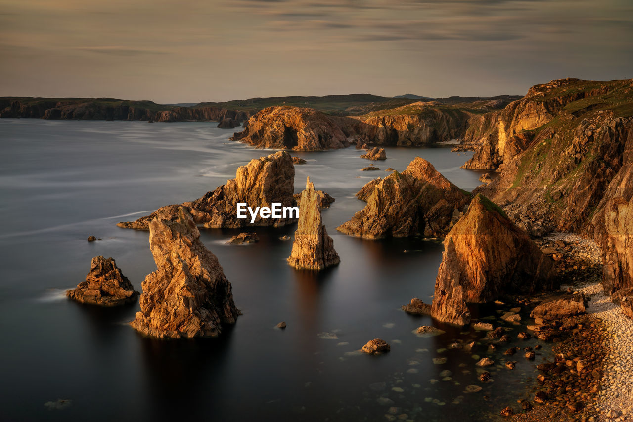 Panoramic view of rocks in sea against sky