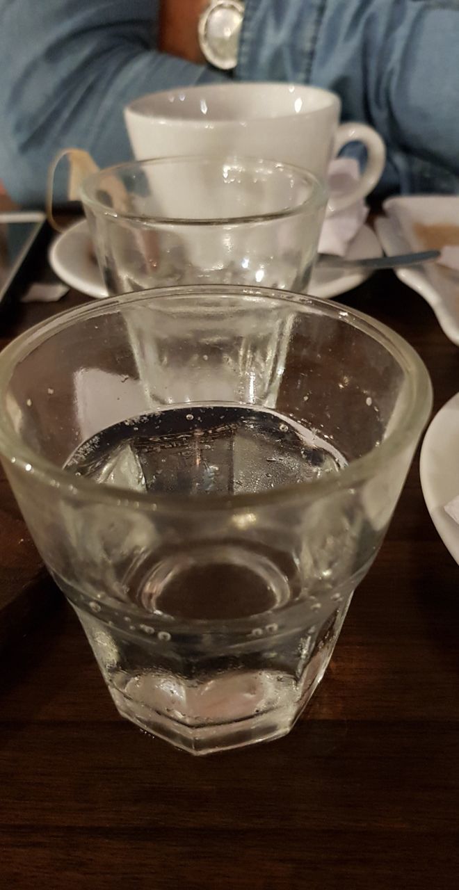 CLOSE-UP OF GLASS OF WATER IN DRINKING GLASSES ON TABLE