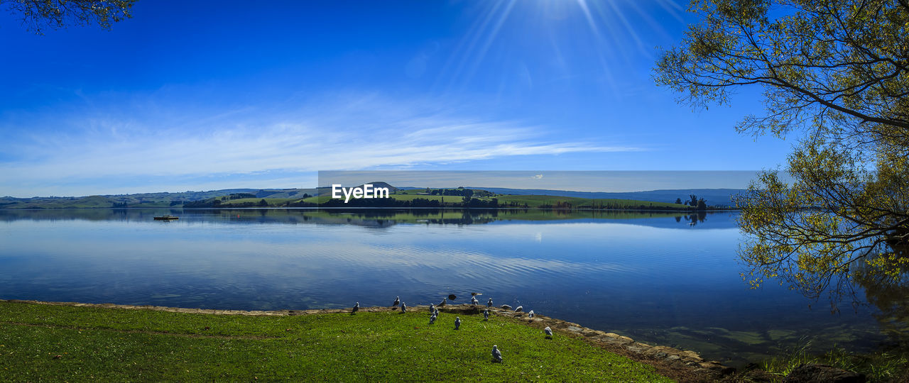 Scenic view of lake against blue sky