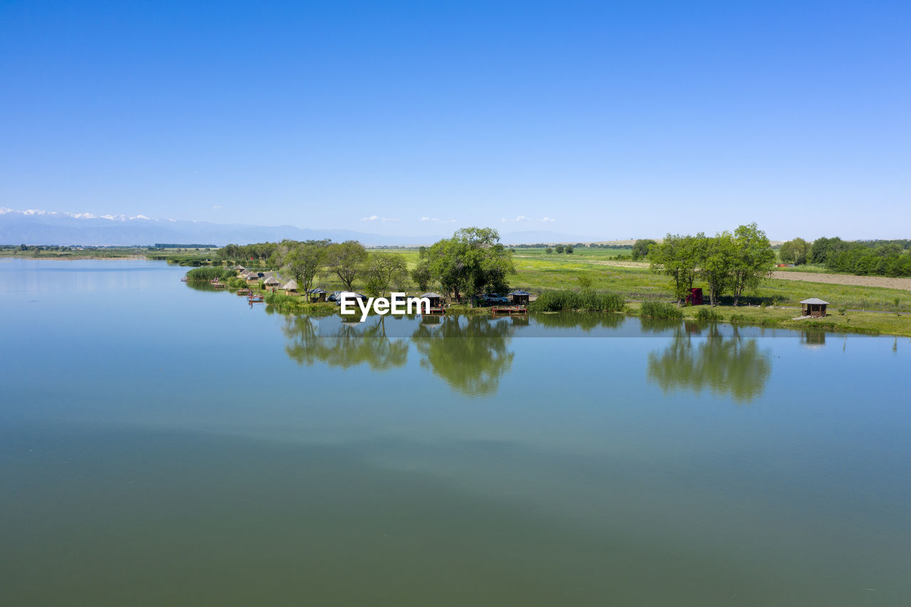 Scenic view of lake against blue sky