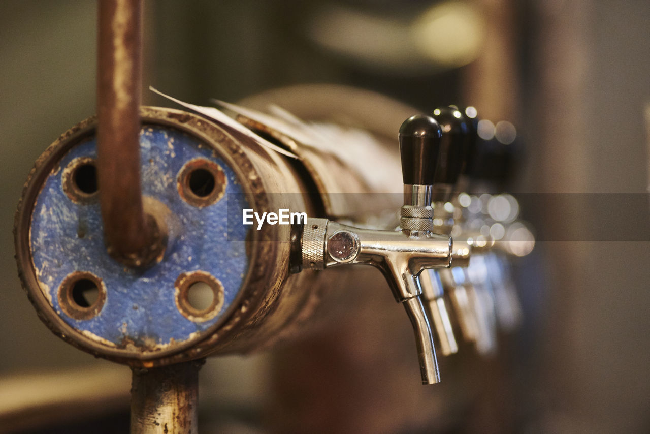 Close-up of beer taps at microbrewery