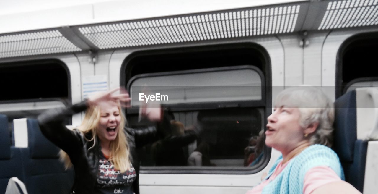 HAPPY WOMAN SITTING ON BUS