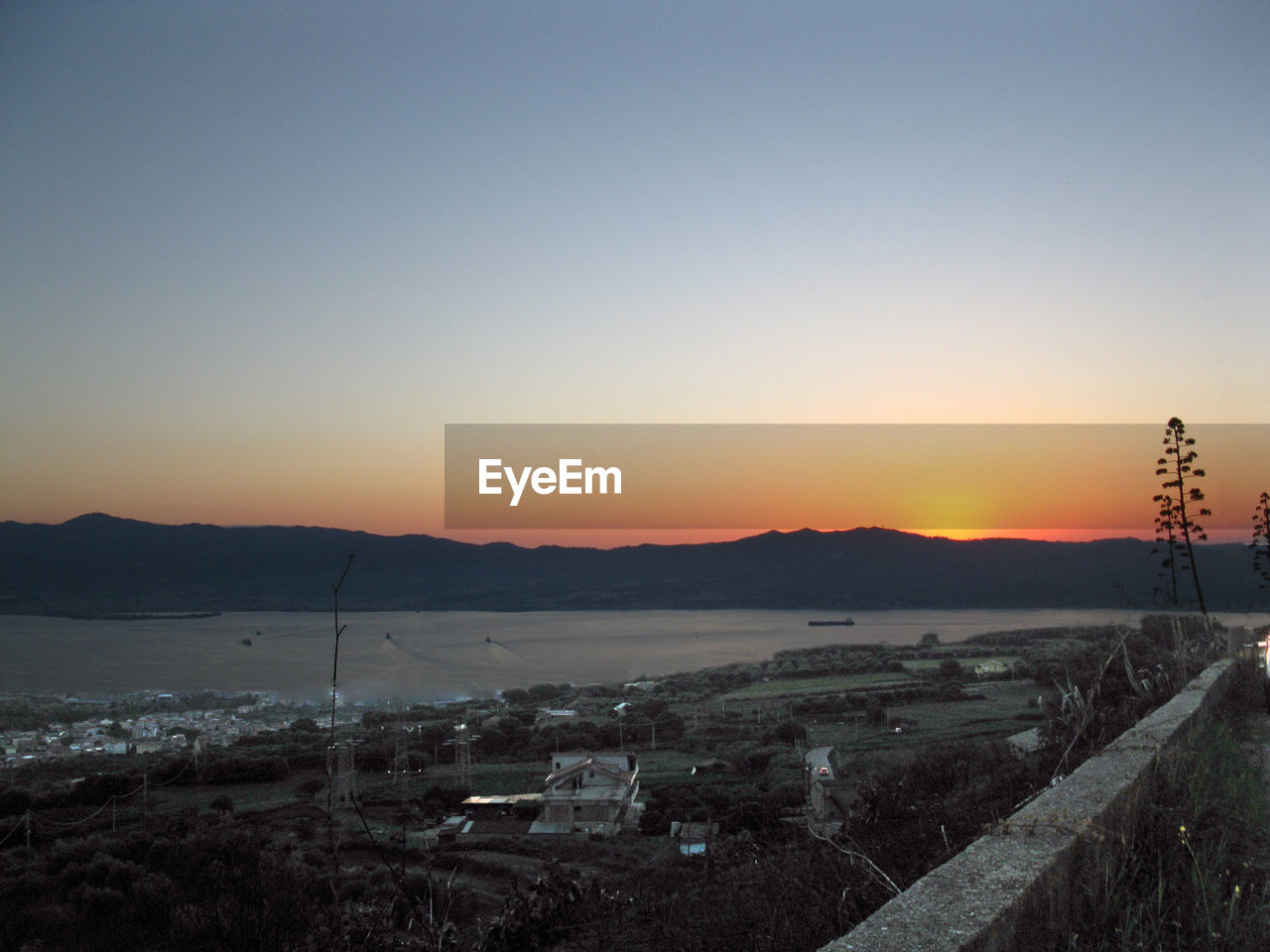 Scenic view of landscape against clear sky during sunset