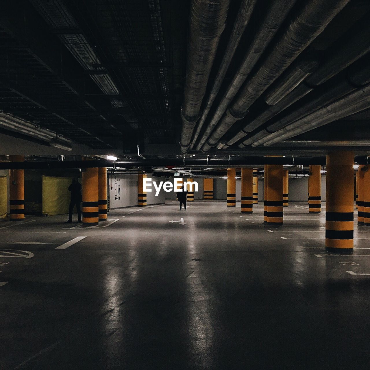 People in empty parking garage