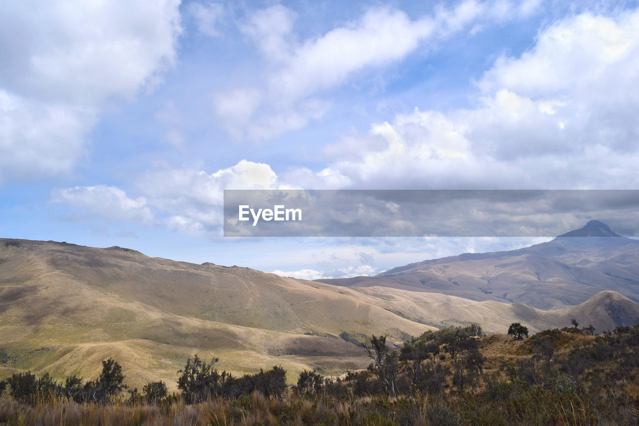 Scenic view of landscape against cloudy sky