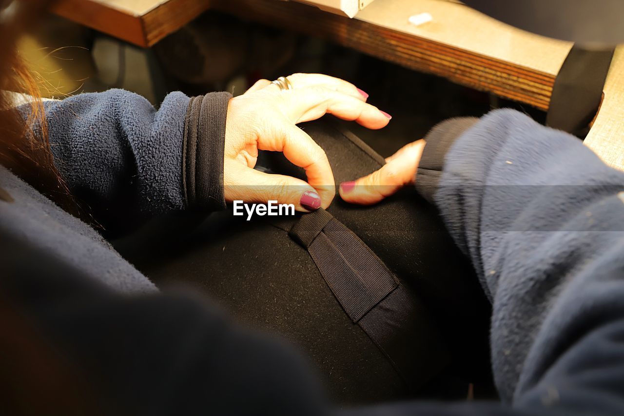 Midsection of woman holding cushion at home