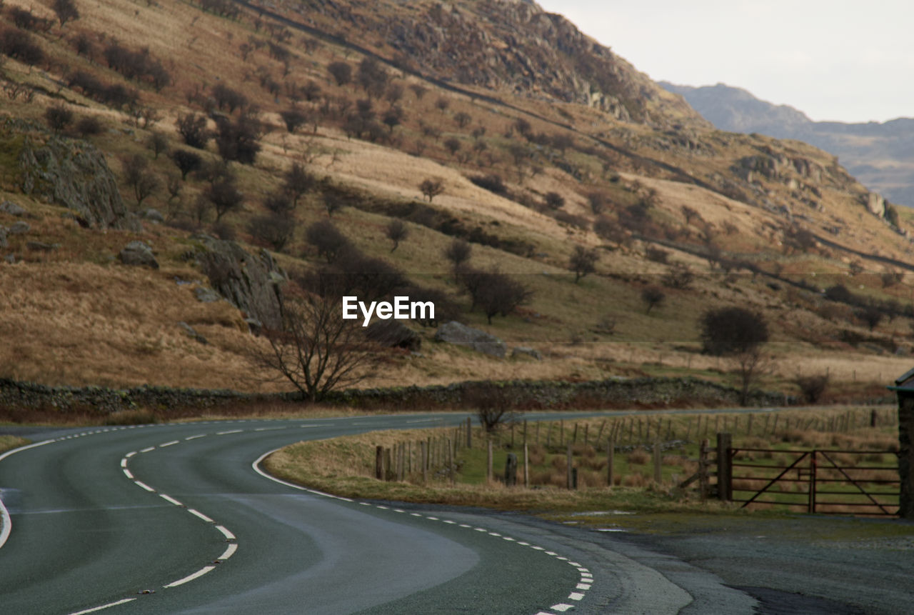 SCENIC VIEW OF ROAD BY MOUNTAIN