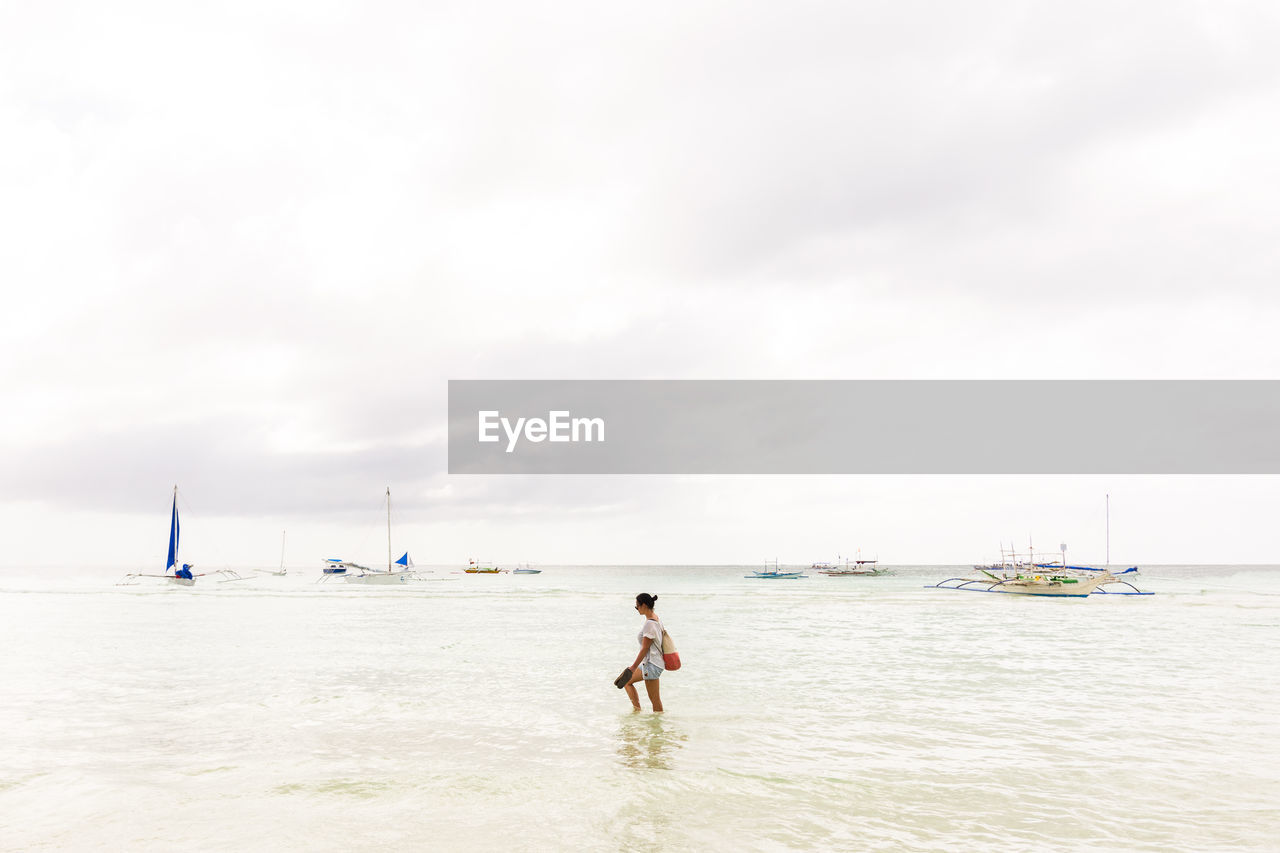 Woman walking in sea