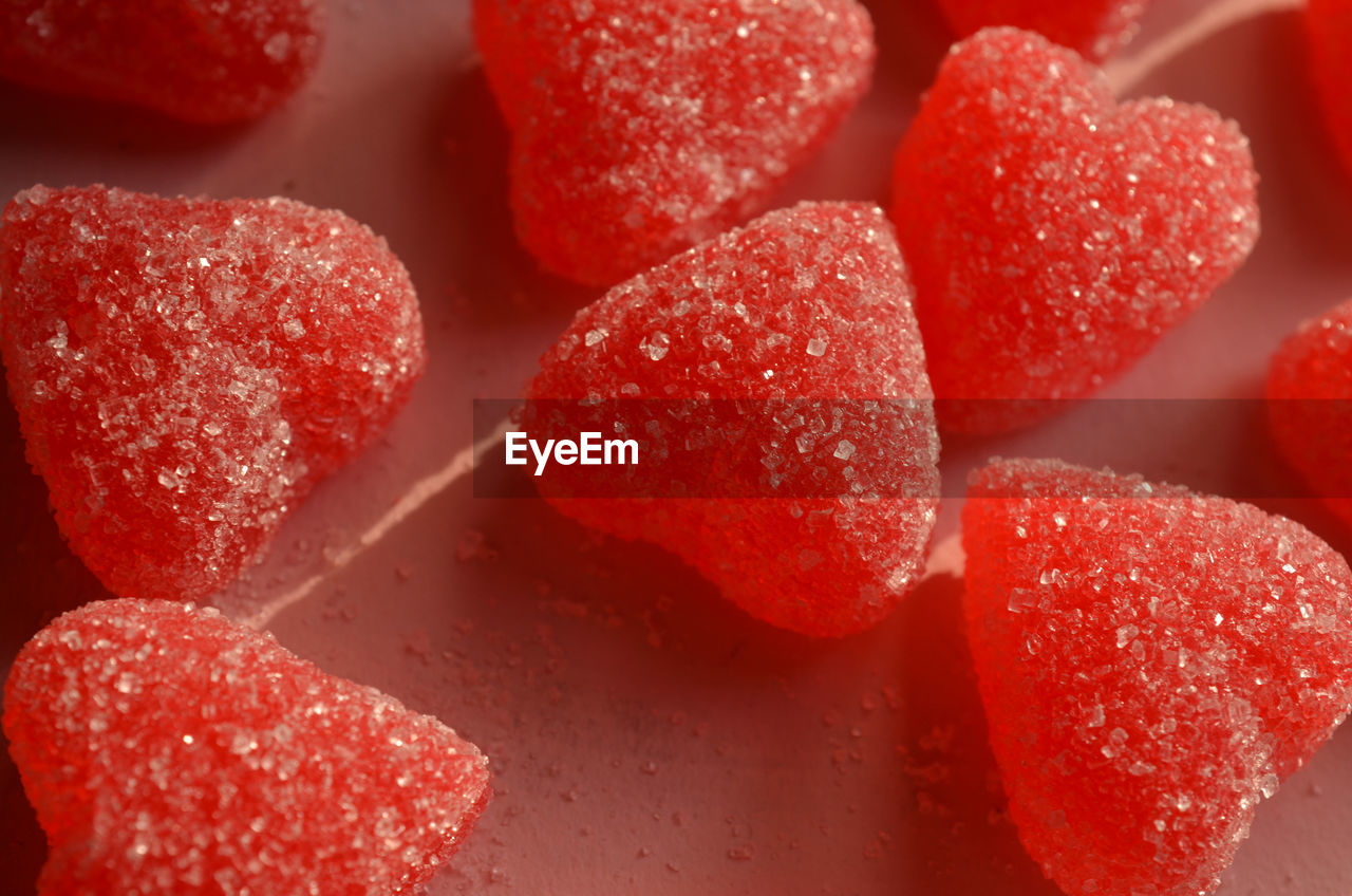 Red jelly candy hearts sugar coated on pink