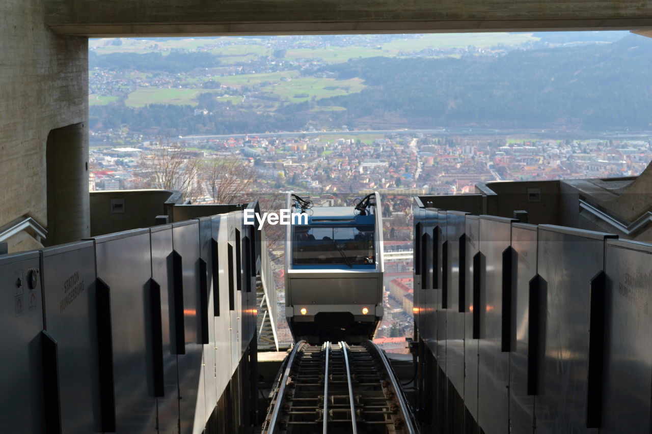 View of a funicular climbing up an escalator with the alps in the background