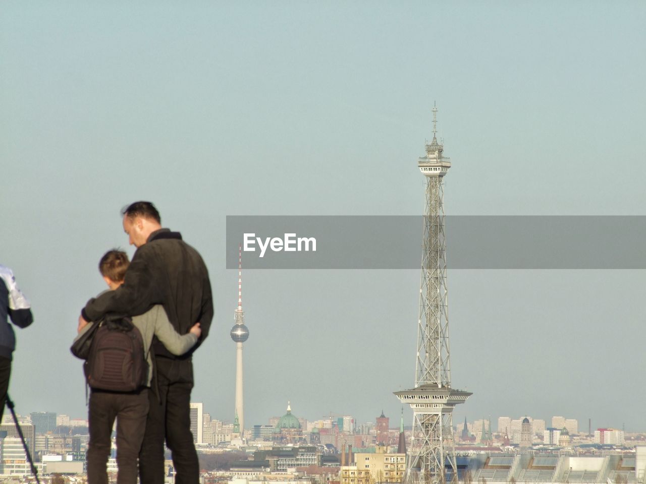 MEN STANDING ON A TOWER