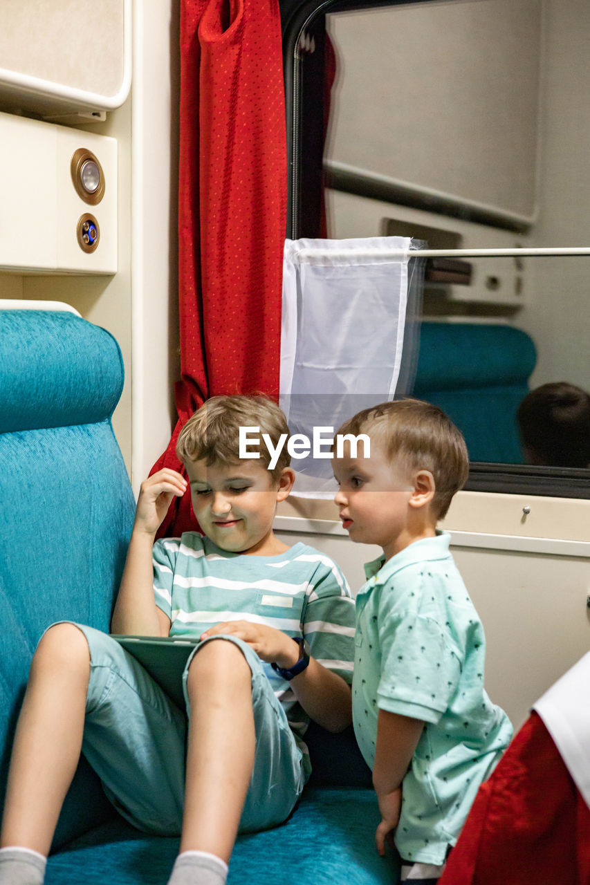 Cute kids sitting in train