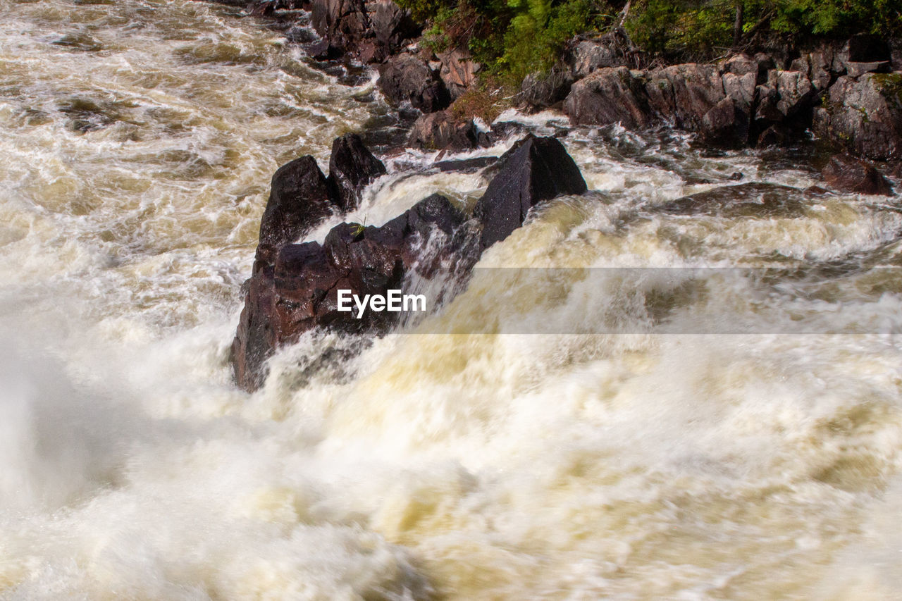rapid, river, water, motion, beauty in nature, nature, rock, scenics - nature, stream, waterfall, sports, flowing water, water feature, splashing, no people, water sports, environment, land, wave, watercourse, outdoors, flowing, speed, body of water, day, power in nature, non-urban scene, blurred motion, long exposure, plant, tree