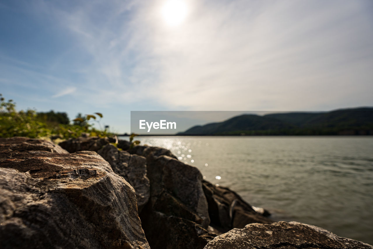 ROCKS IN SEA AGAINST SKY