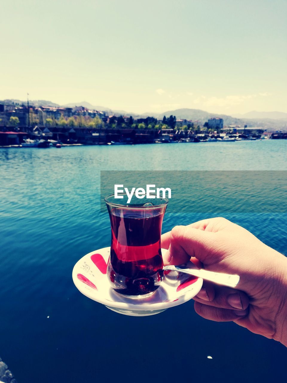 MAN DRINKING GLASS AGAINST WATER