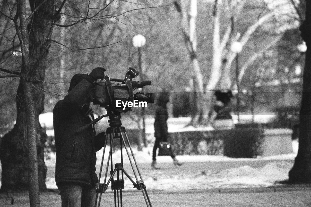 Man photographing with camera during winter