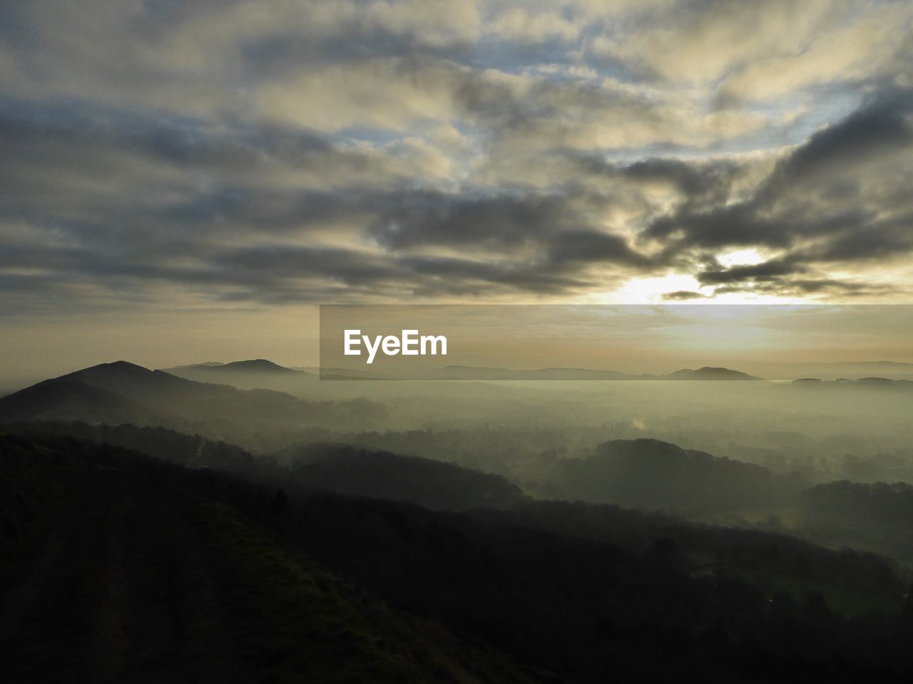 Scenic view of silhouette mountains against sky during sunset