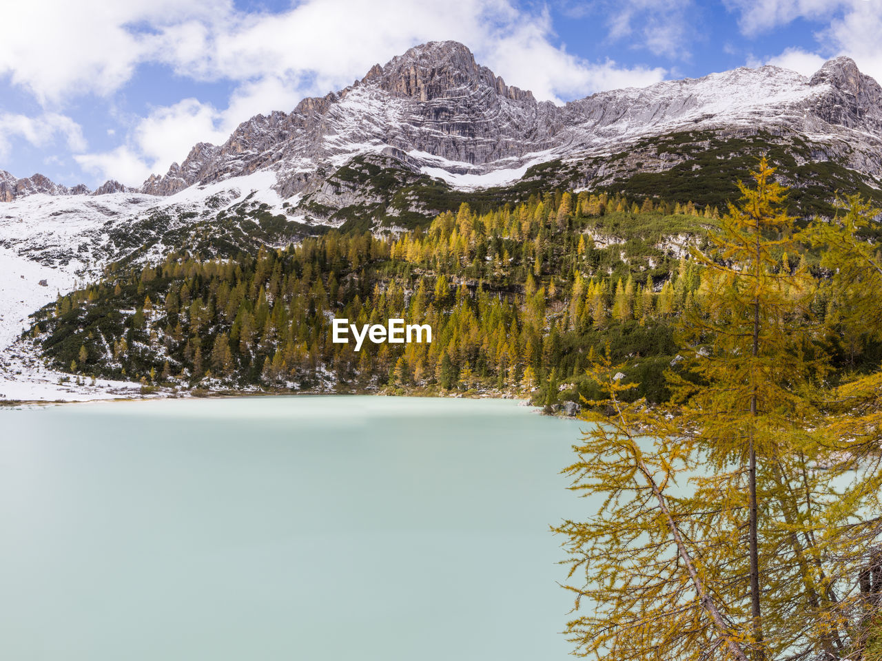 Lake sorapis in autumn with early snow in dolomites italy