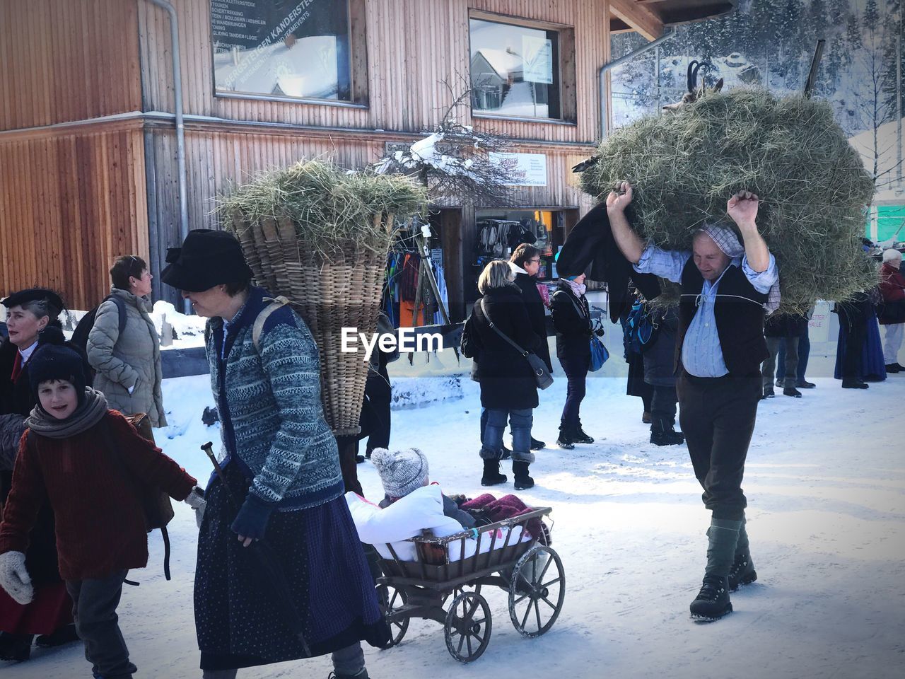 PEOPLE WALKING ON SNOW DURING CHRISTMAS