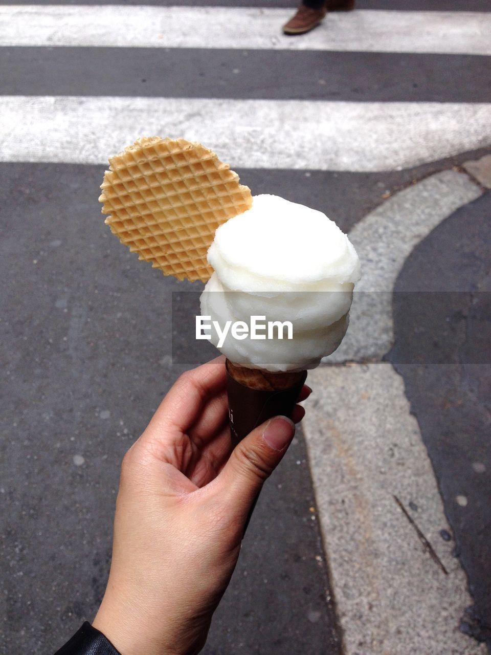 Cropped hand holding ice cream