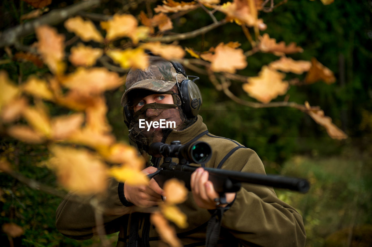 Teenage boy with rifle at hunting