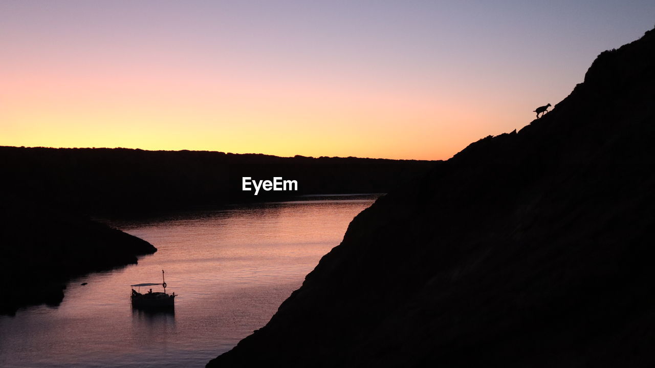 Scenic view of silhouette mountains against sky during sunset