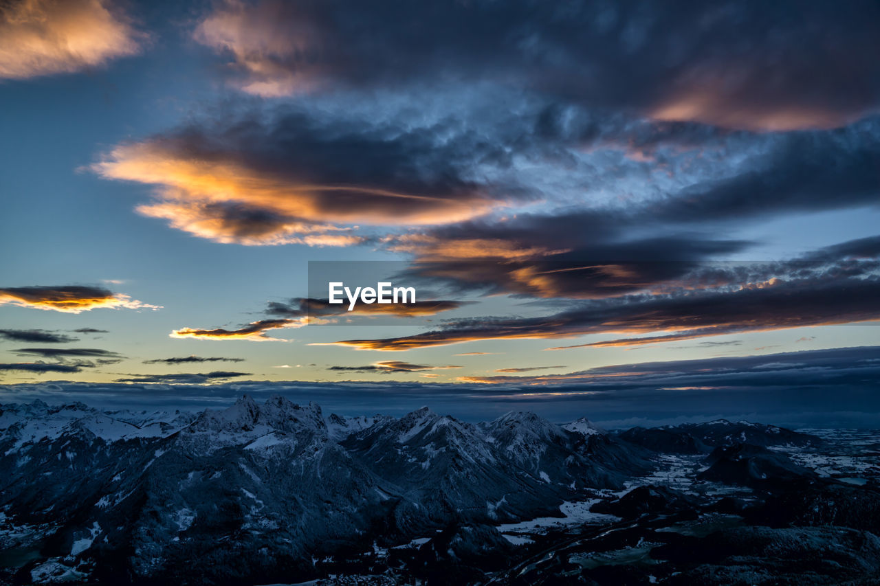 Scenic view of snowcapped mountains against dramatic sky