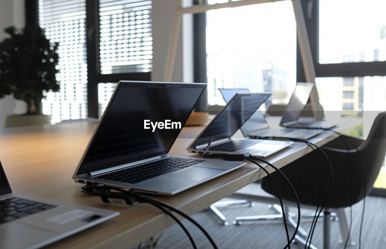 computer, laptop, technology, wireless technology, furniture, window, table, business, office, indoors, communication, chair, office building, desk, office chair, room, seat, no people, internet, corporate business, place of work, portability, using laptop, computer equipment, interior design, computer network, day, home interior, computer monitor, architecture, convenience, glass