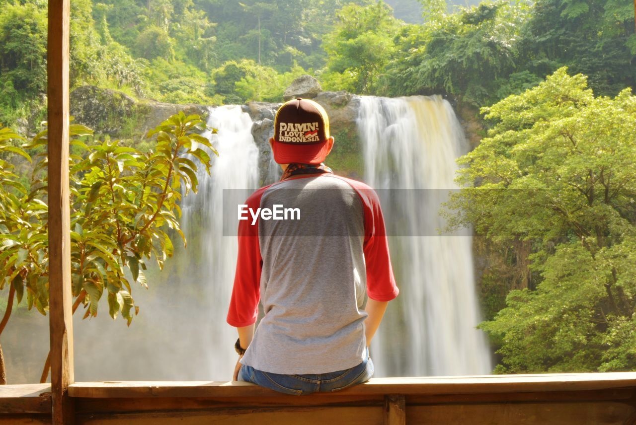 View of man looking at sodong waterfall in forest