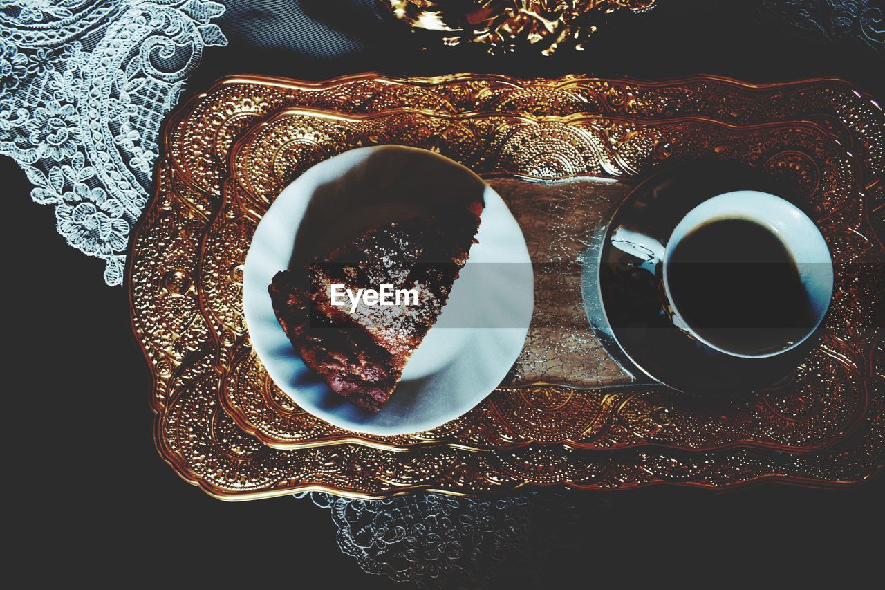 Directly above shot of coffee and bread on tray