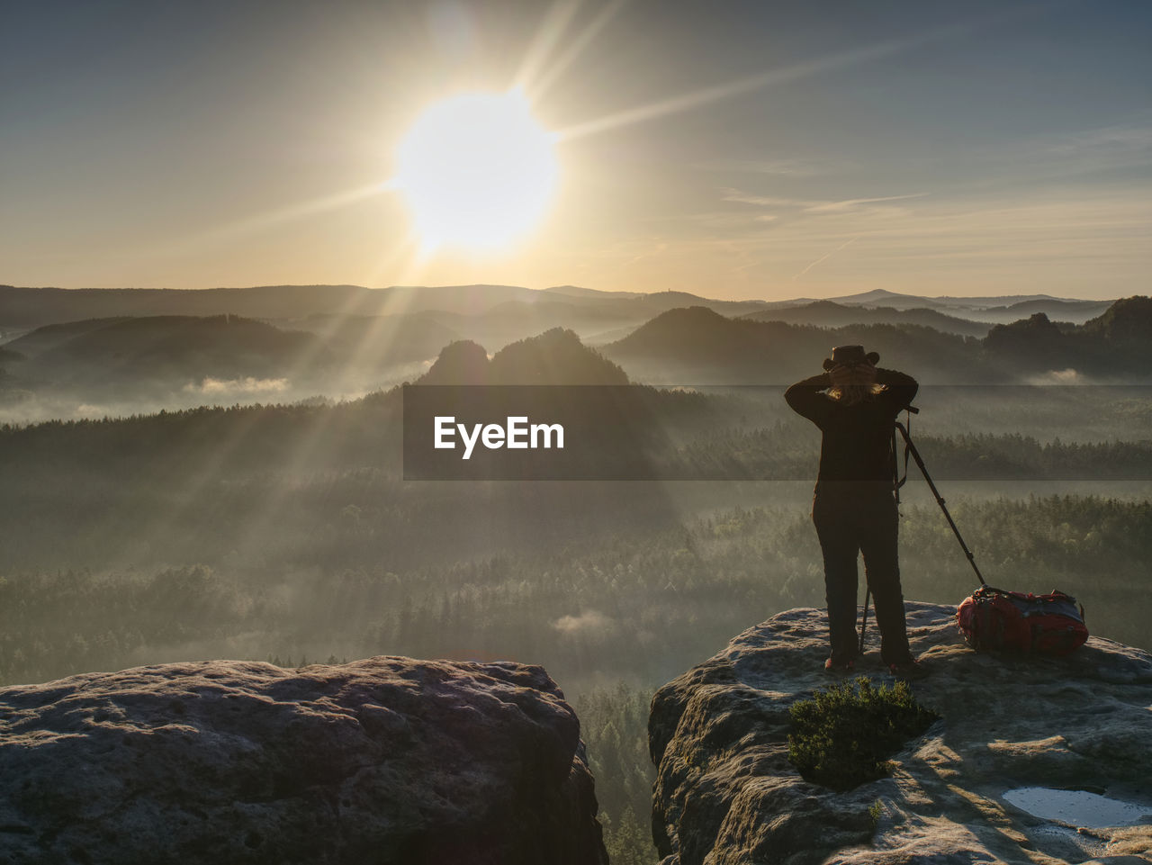 Girl frind photographer artist working on edge. view point on high mountain peak with circle view