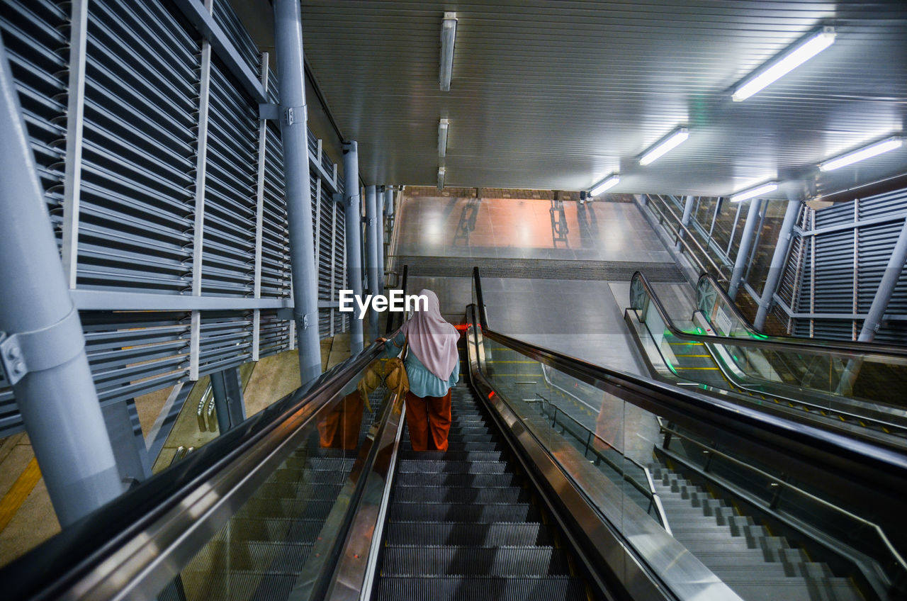 Women in the escalator are downhill to get out of mrt btho, cheras.