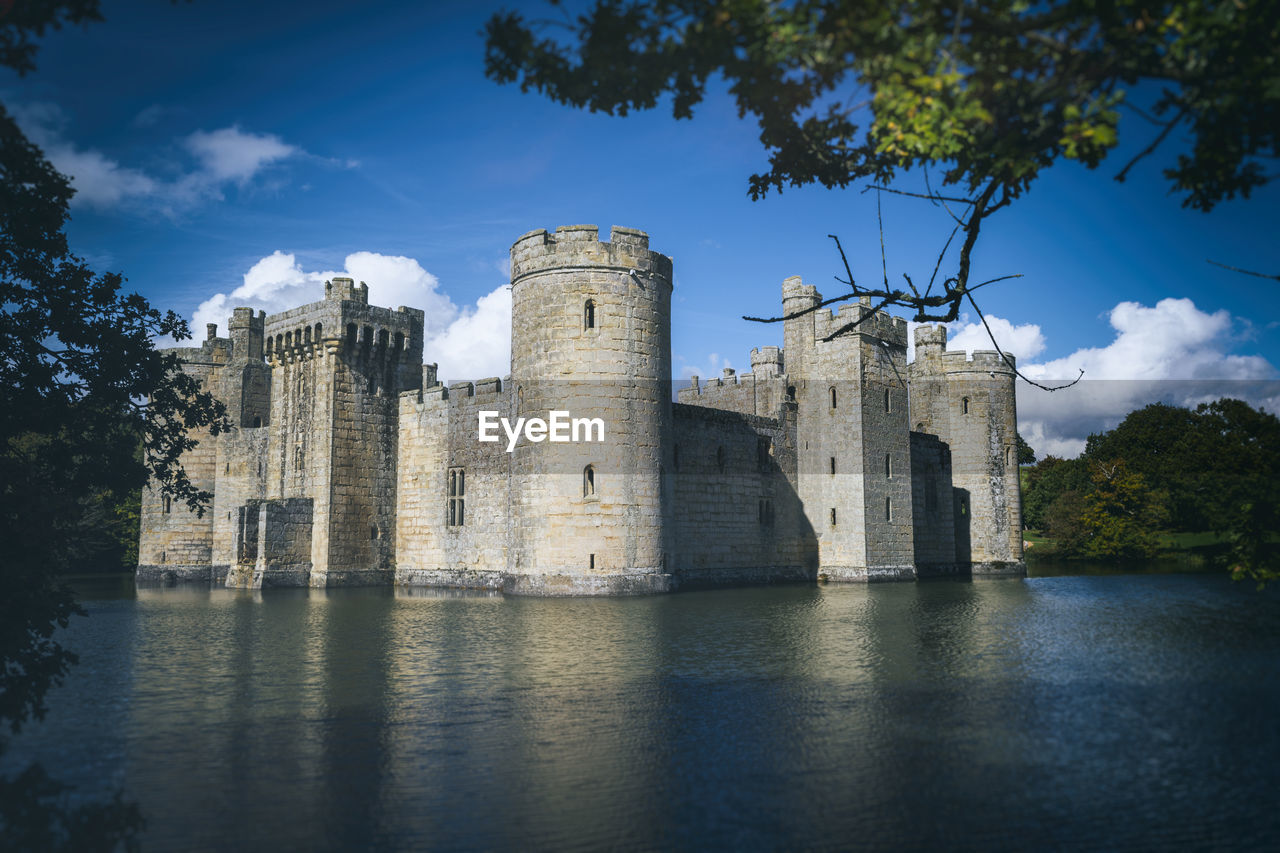 CASTLE BY WATER AGAINST SKY