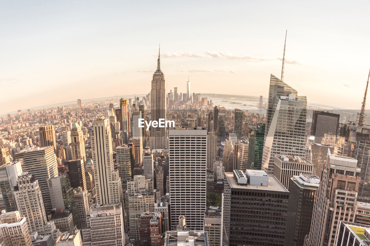 AERIAL VIEW OF MODERN BUILDINGS IN CITY AGAINST SKY