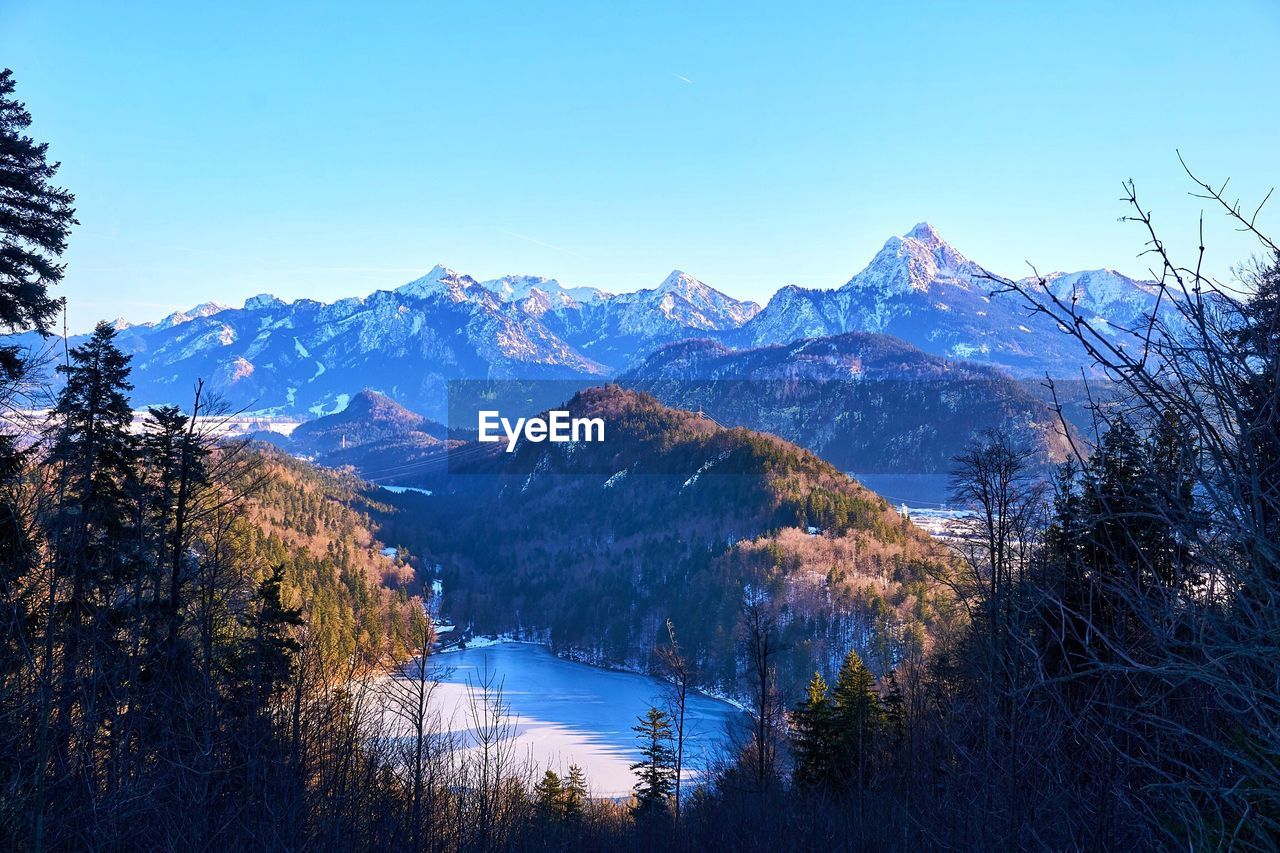 Scenic view of mountains against clear blue sky