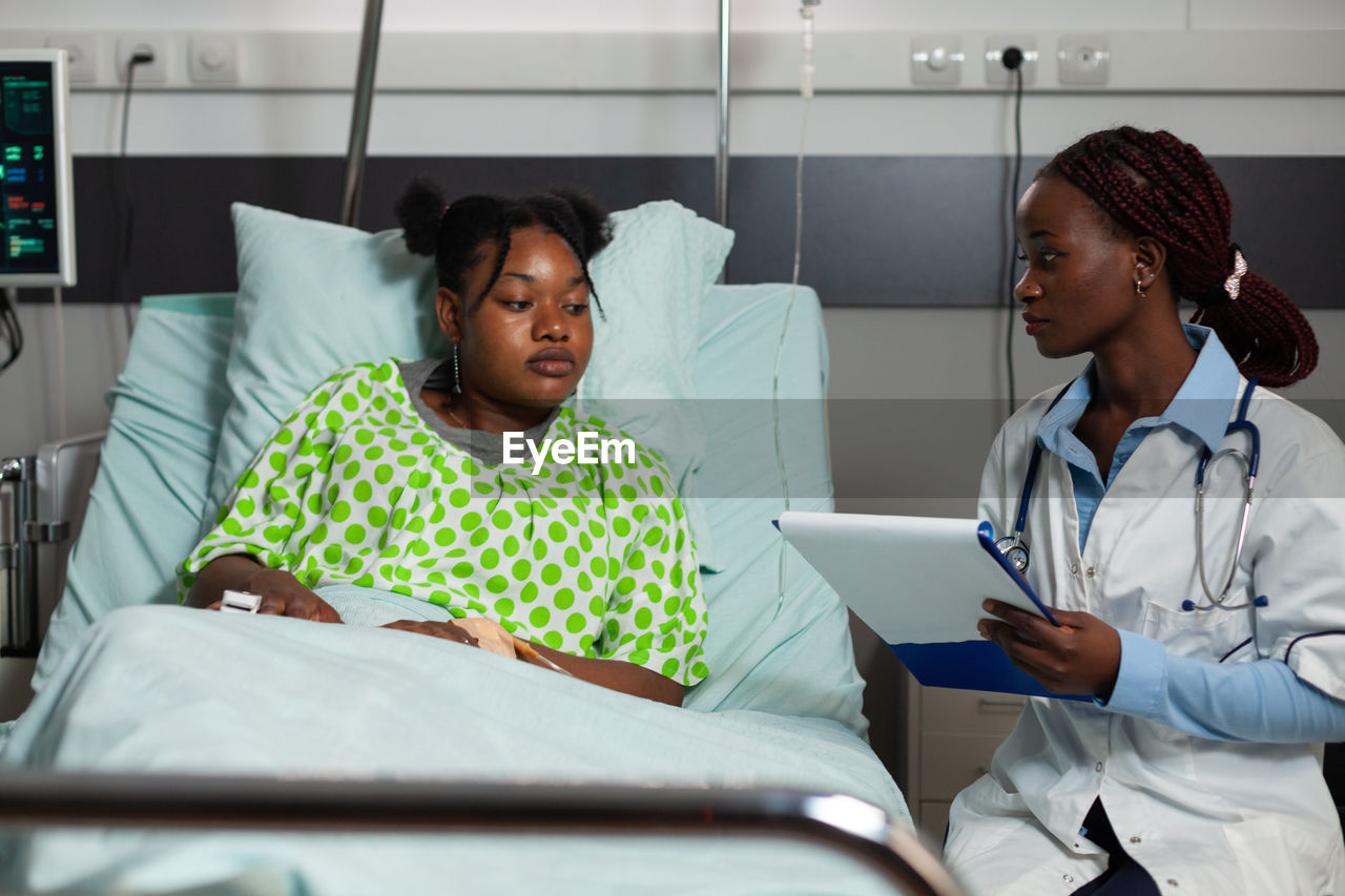 portrait of young woman using digital tablet in hospital