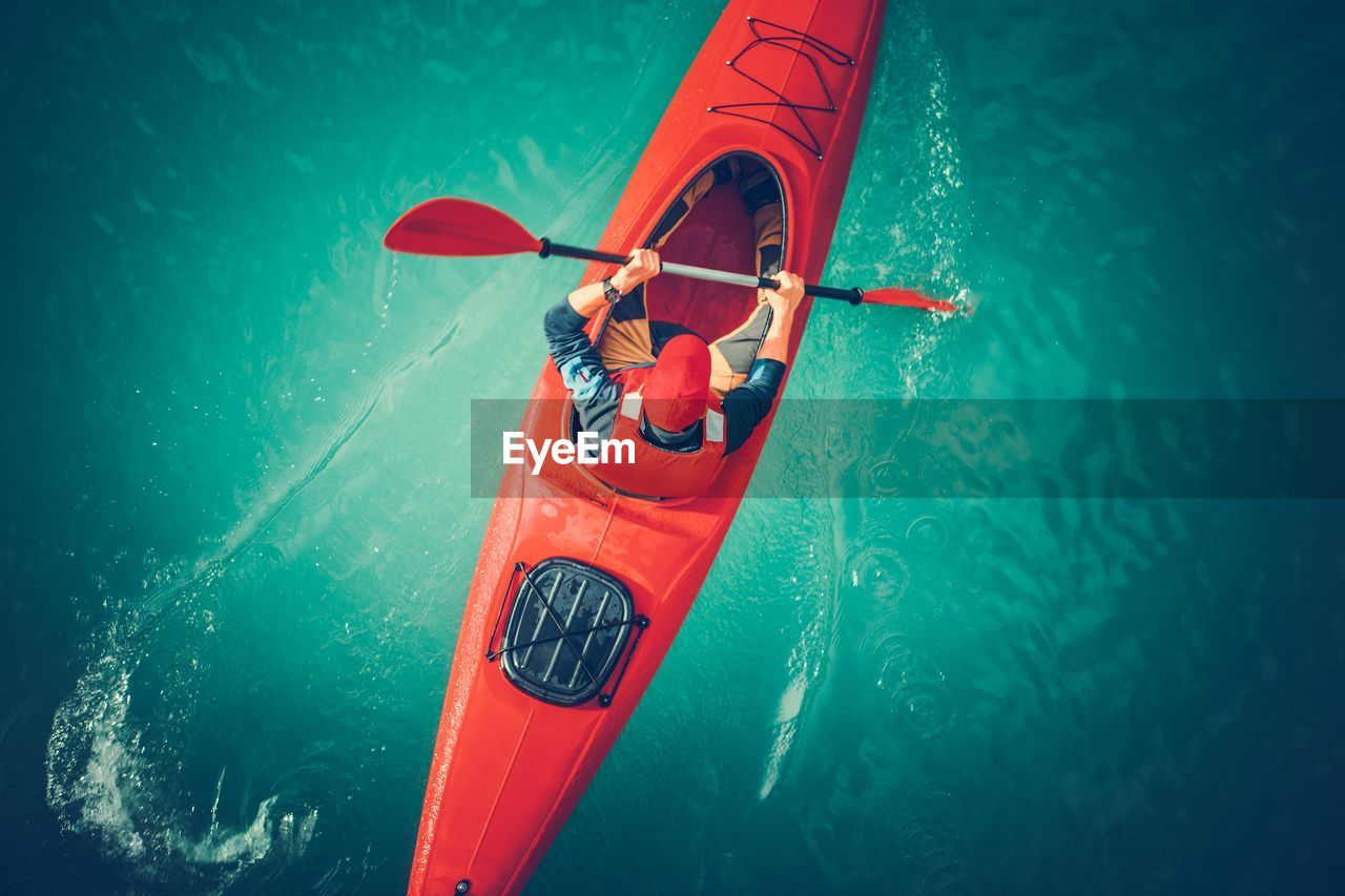 High angle view of mid adult man kayaking on sea