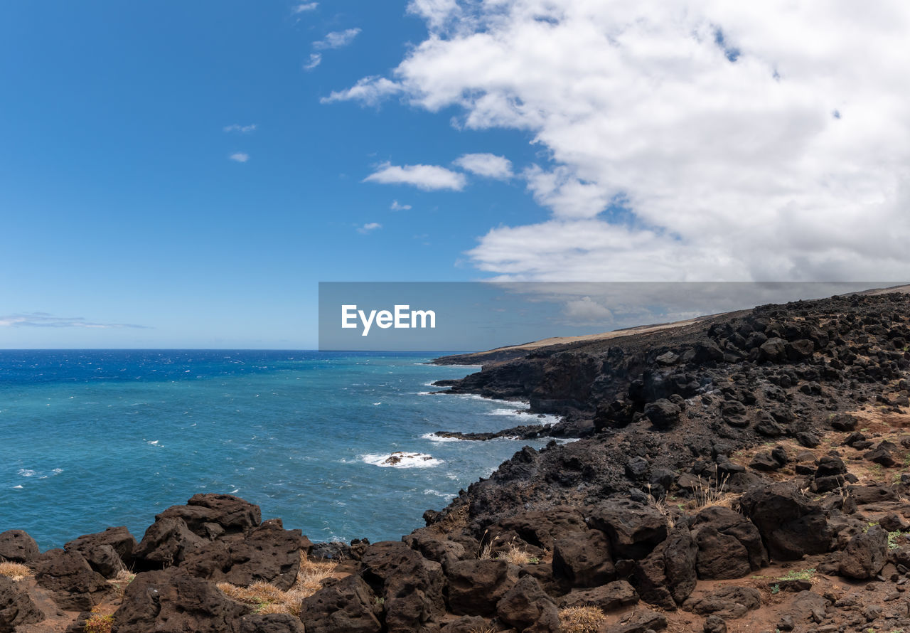 SCENIC VIEW OF ROCKS ON SEA AGAINST SKY