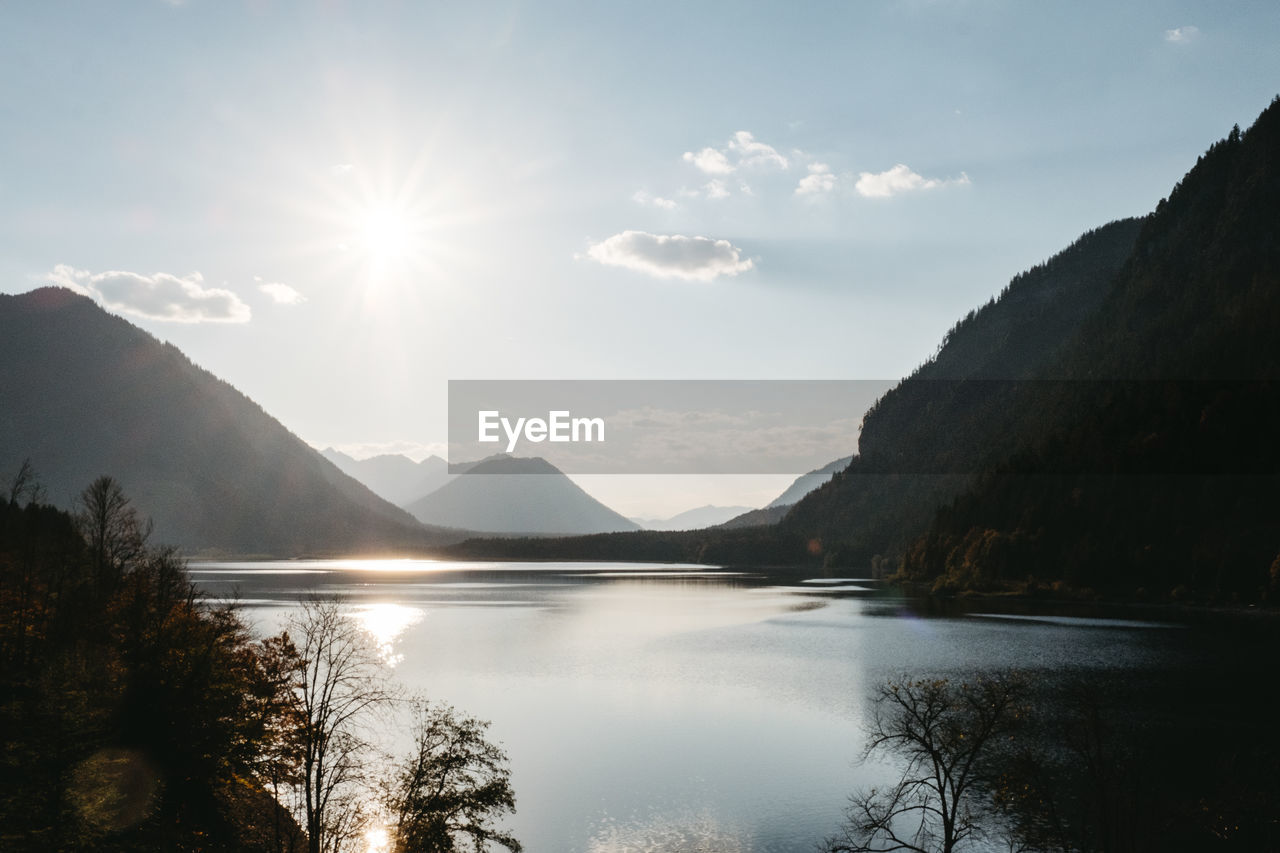 Scenic view of lake and mountains against sky