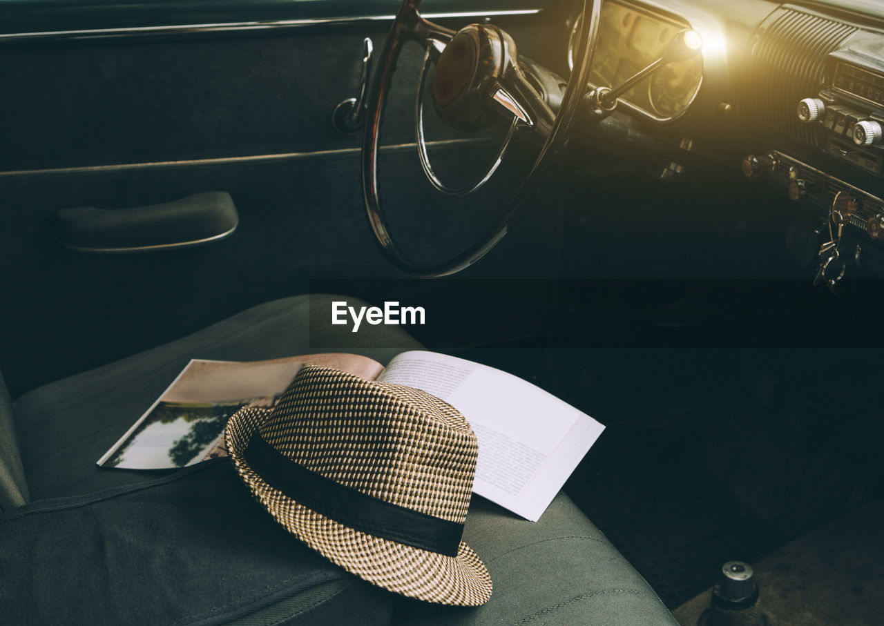 High angle view of hat and magazine on car seat