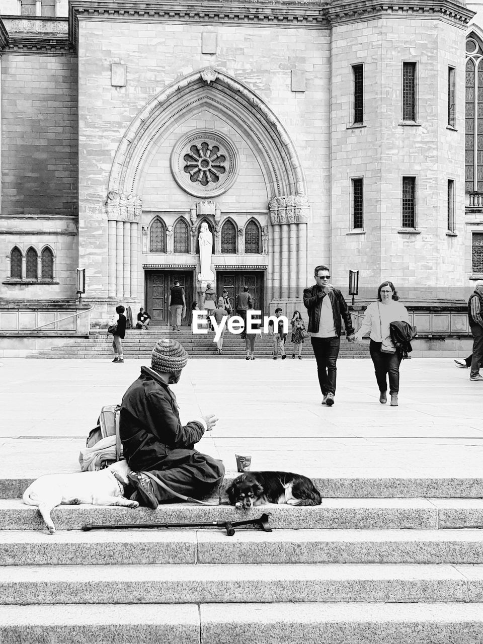 PEOPLE SITTING OUTSIDE CATHEDRAL