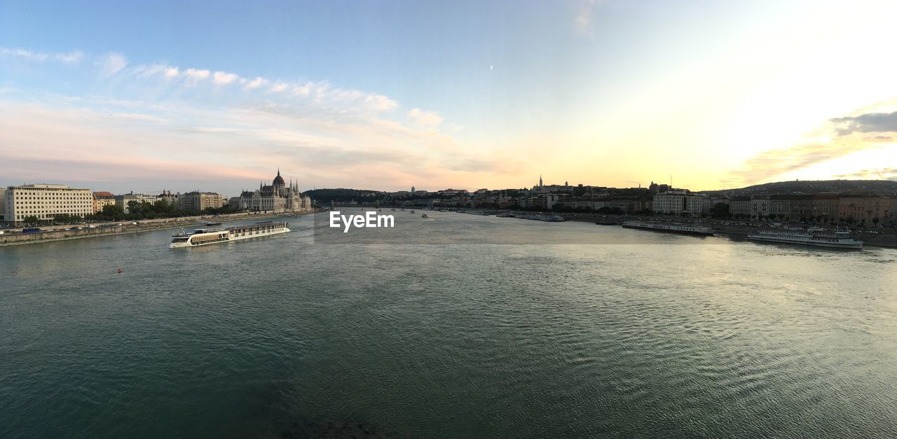 VIEW OF BRIDGE OVER RIVER AGAINST BUILDINGS