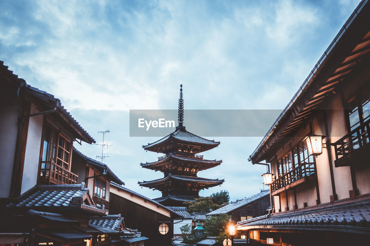 Pagoda and buildings in city against sky