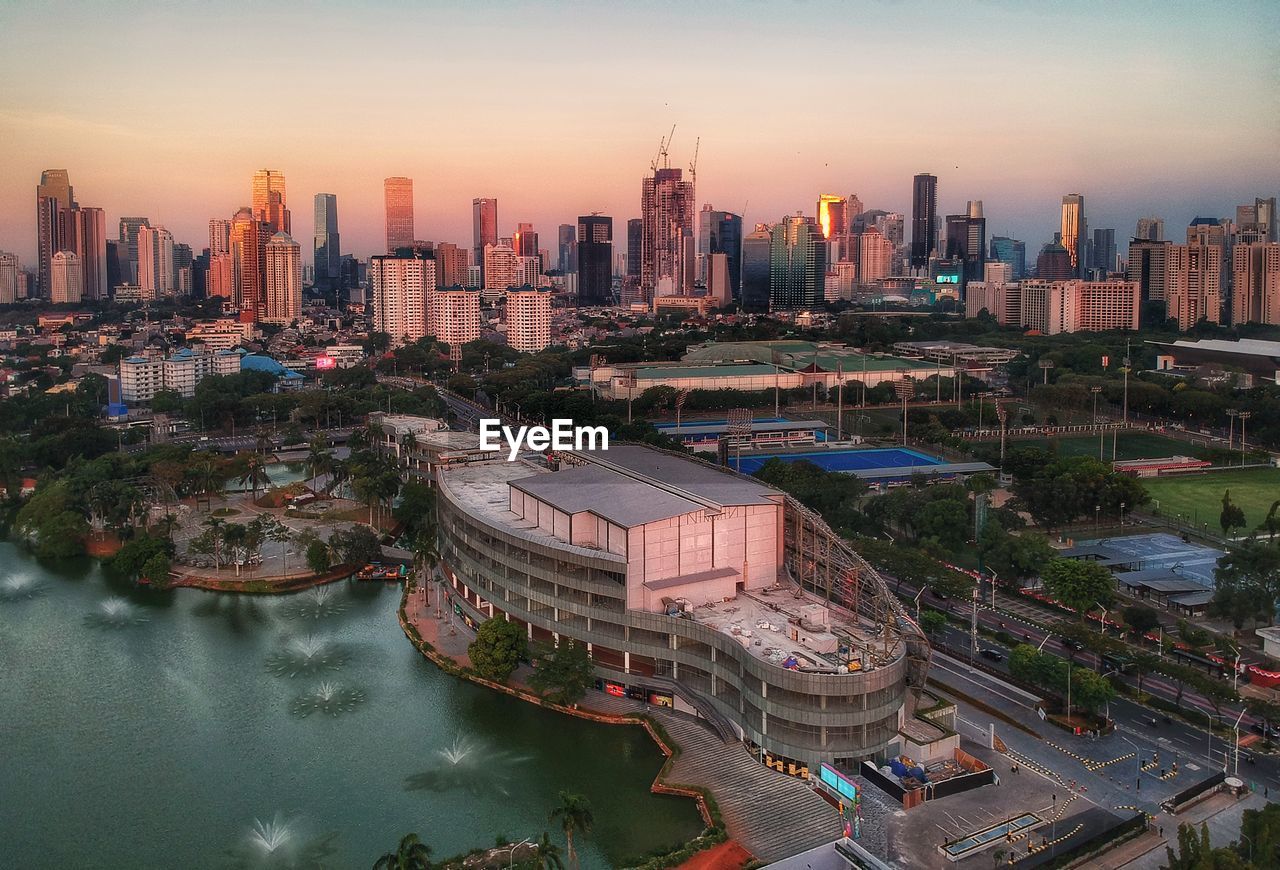 High angle view of river amidst buildings in city against sky
