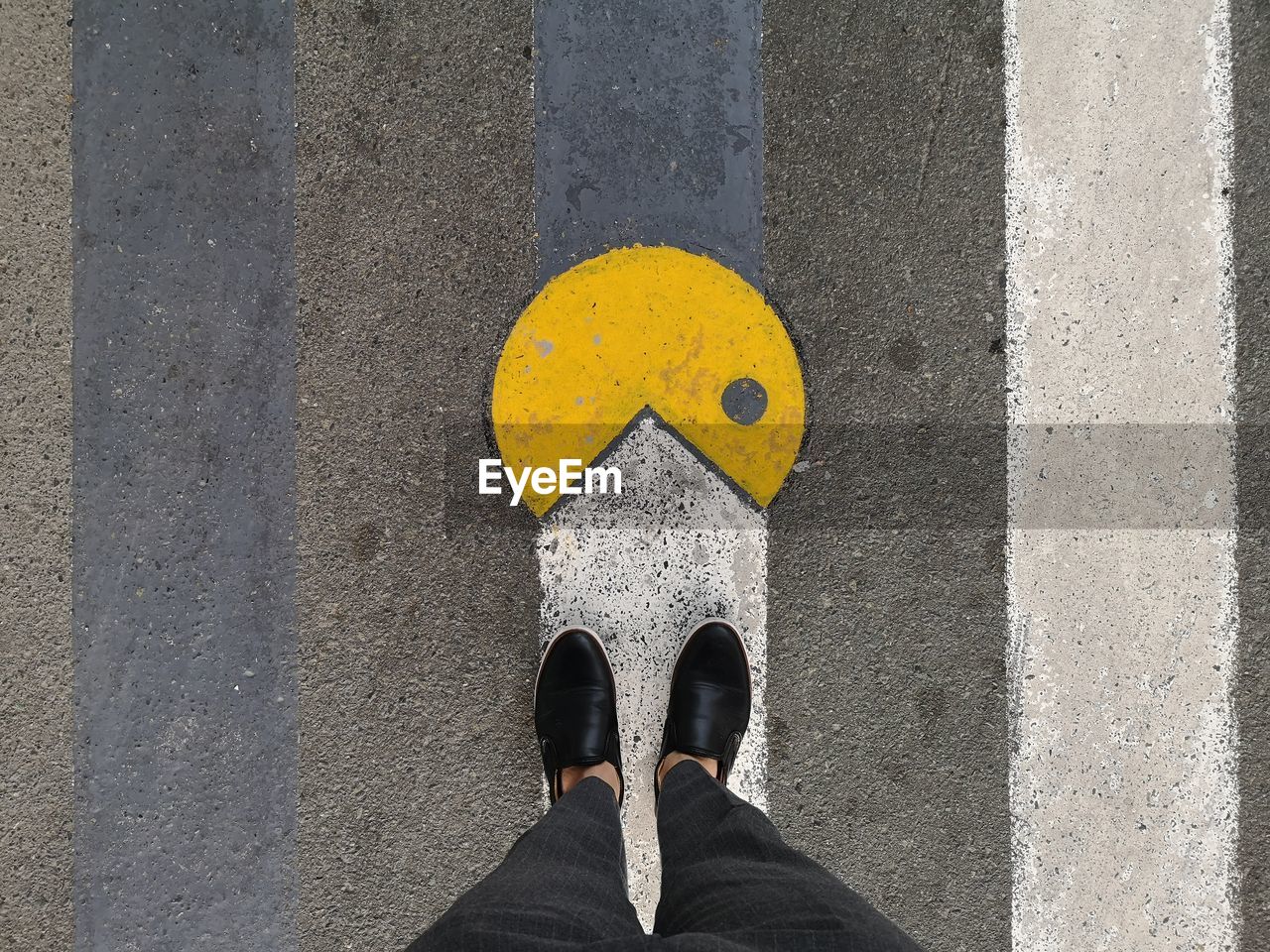 Low section of person standing on road