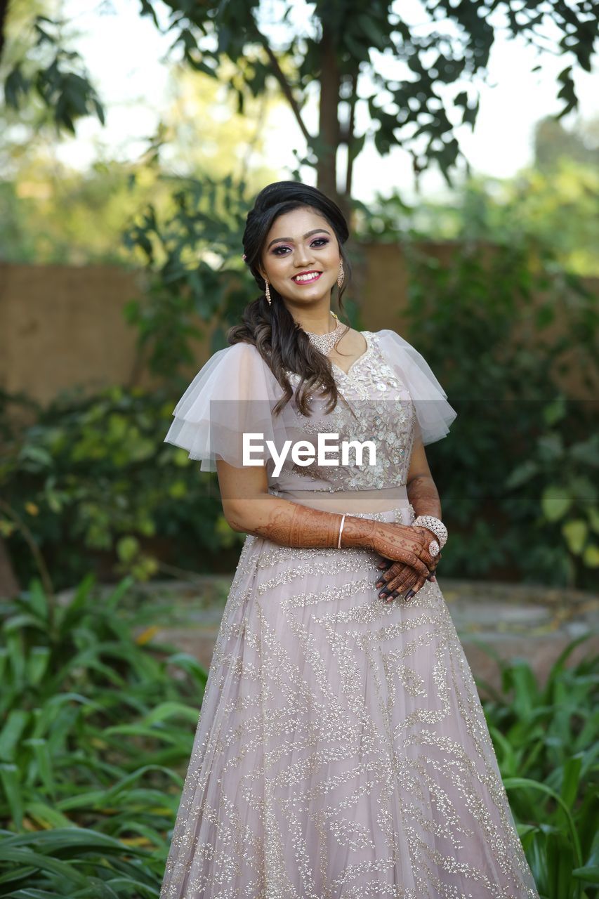 Portrait of a smiling young woman standing outdoors