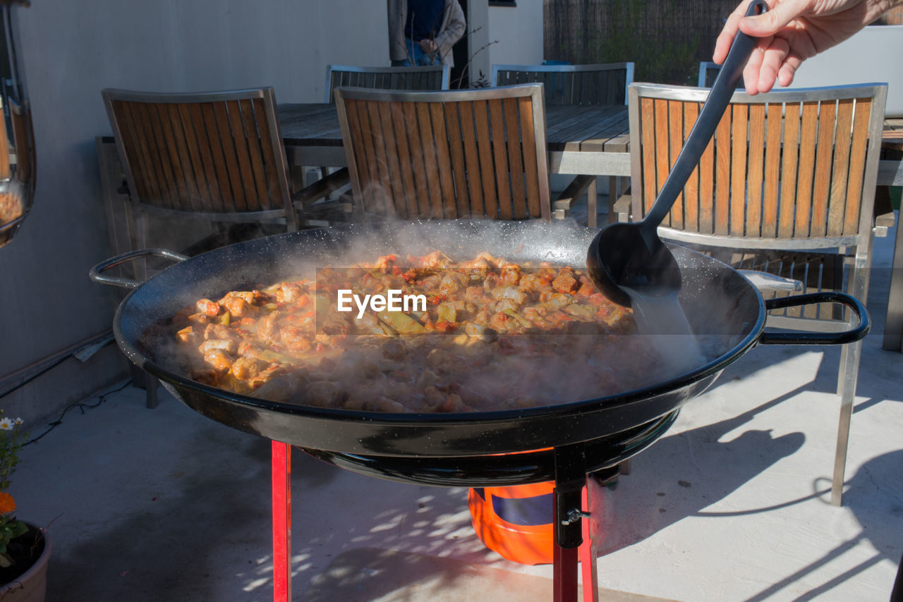 food and drink, food, heat, kitchen utensil, barbecue, dish, burning, meat, barbecue grill, cooking, fire, cuisine, freshness, flame, day, hand, household equipment, cooking pan, grilling, outdoor grill, grilled, nature, one person, preparing food, outdoors, adult, meal, men, fried