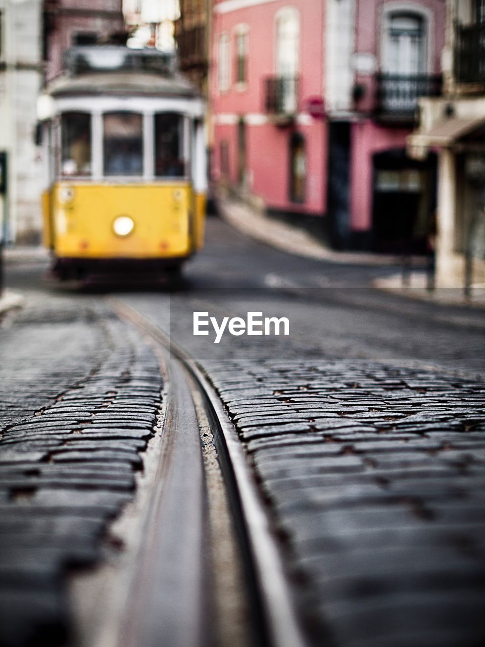 Tram by buildings in city