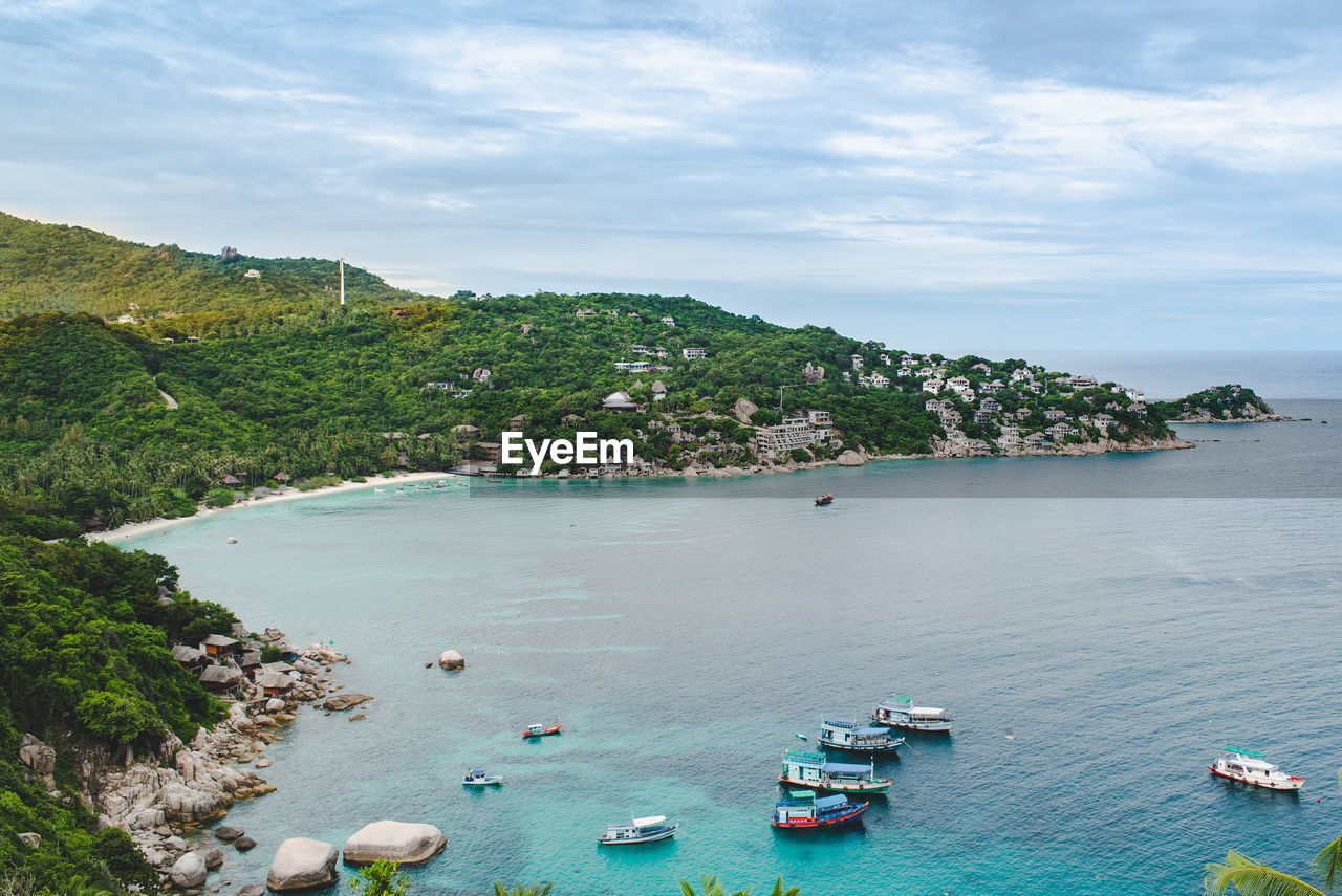 High angle view of boats on sea shore against sky