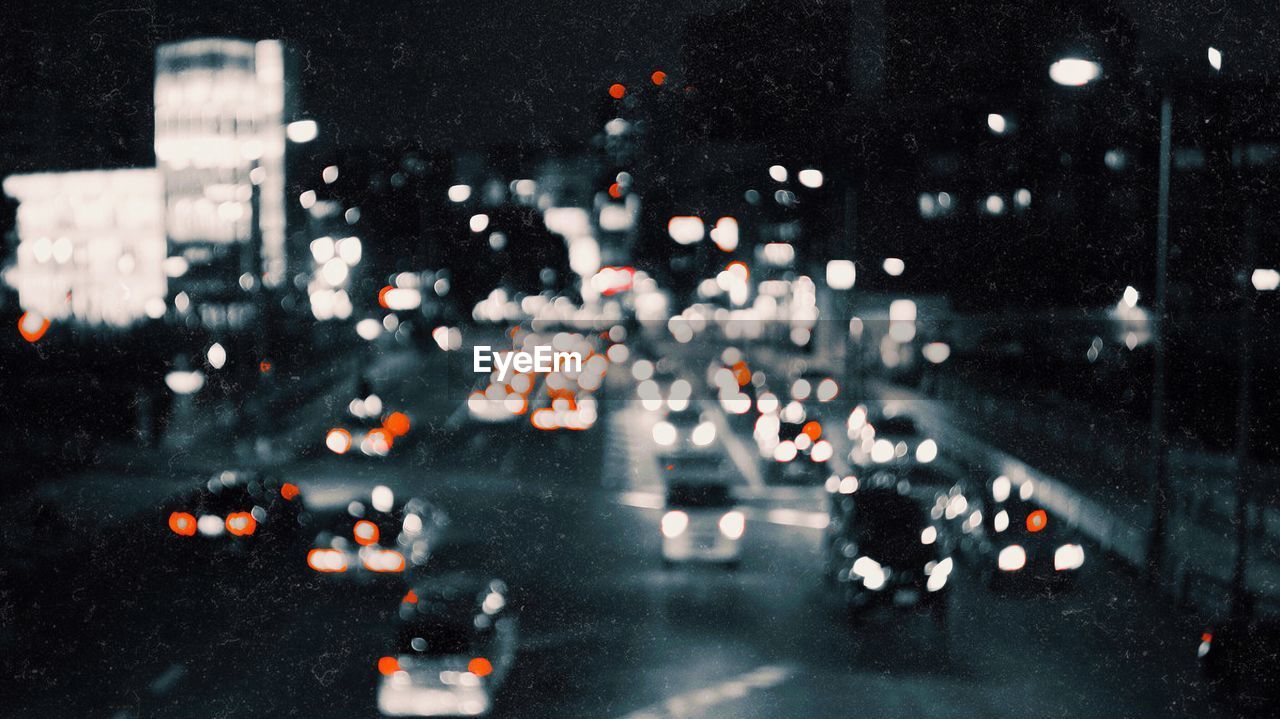Defocused image of traffic on road at night